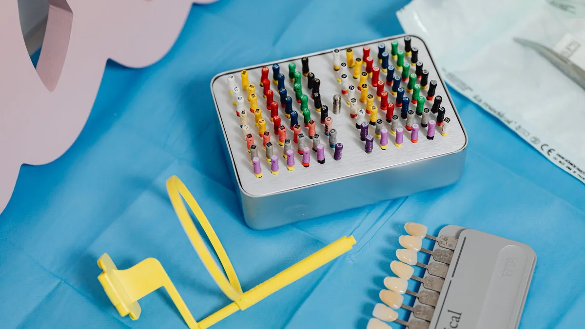 A vibrant collection of dental tools displayed on a sterile blue cloth ready for dental use.