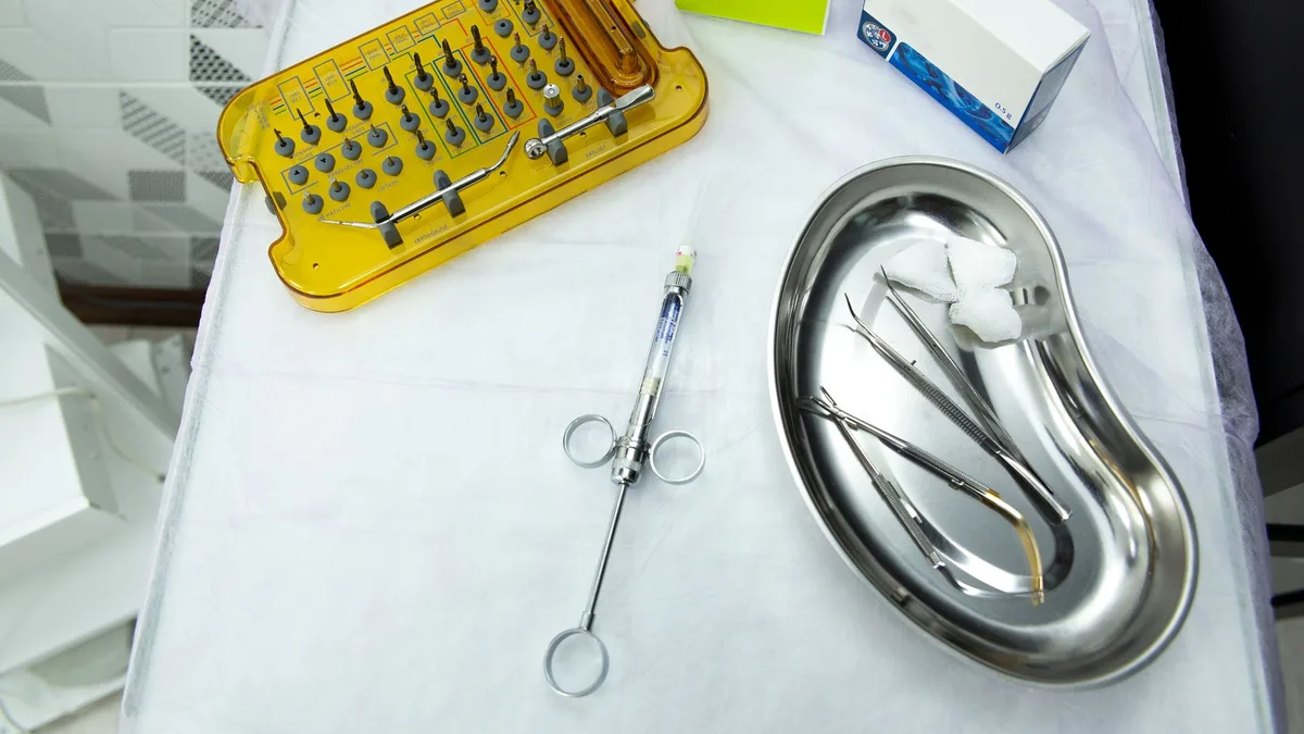 A set of dental and medical tools on a sterile tray, ideal for clinical and healthcare settings.
